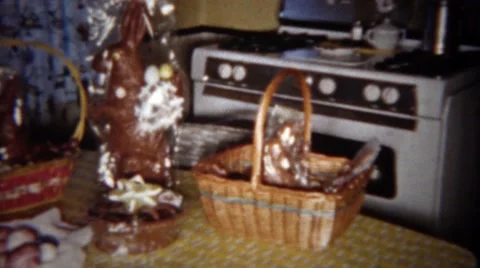 1963: Easter Baskets on Kitchen Table with Giant Chocolate Candy Rabbit. Vídeos de archivo 58685392