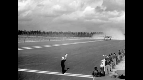 1963 - Heavy bombers take off from an airfield and an aircraft carrier during Stock Footage