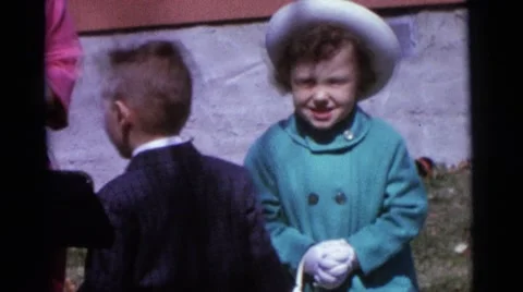 1963: kid wanders around as family struggles to take family portrait CAMDEN Stock Footage