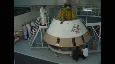 1963 - NASA technicians look over a boiler plate prototype for a spacecraft. Stock Footage 232849900