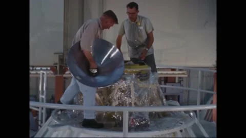 1963 - NASA technicians secure the airlock cover onto a command module. Stock Footage 232851954