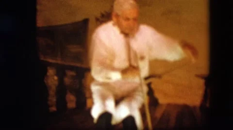 1963: an old man is playing on strange instrument CALIFORNIA Stock Footage