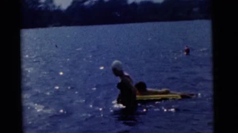 1963: two mothers with children learning to swim CAMDEN, NEW JERSEY Stock Footage