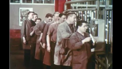 1963 - workers use timeclock to clock in and a man is seen at work in a Ford Stock Footage 119013669