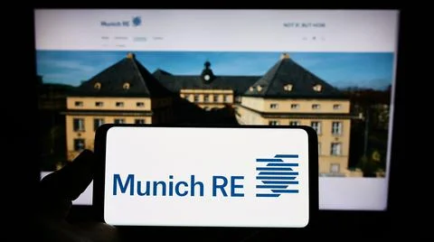 Person holding mobile phone with logo of German insurance company Munich Re Group on screen in front of business web page. Focus on phone display. xkwx advertisement, background, brand, business, business logo, cellphone, company, company logo, computer, dax, device, display, editorial, ergo, euro stoxx 50, finance, financial, front, german, germany, gesellschaft, homepage, illustrative, illustrative editorial, industry, insurance, internet, listed, logo, marketing, mobile phone, munich, munich re, munich re group, munichre, munichre com, online, public, screen, selective focus, services, site, smartphone, stock, trademark, web page, website