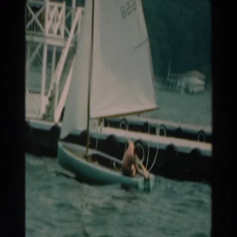 1964: Boy Going Sailing from Dock at Lake Winnebago Wisconsin Stock Footage 69418063