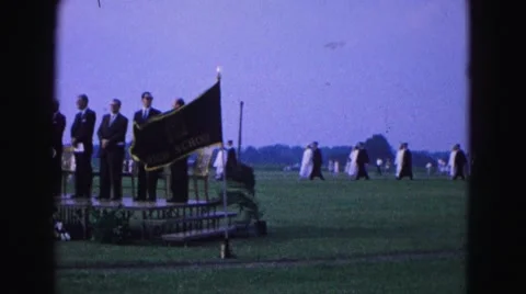 1964: creepy cult like ceremony adult men standing on podium marching background Stock Footage