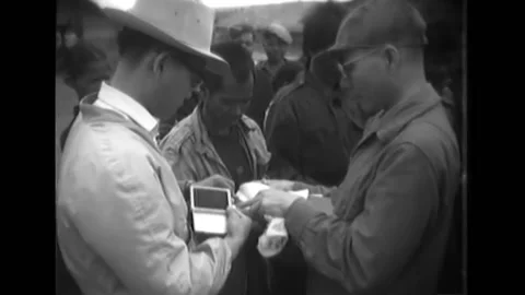1964 - Major Vo Van Ba, Province Chief, distributes money to the heads of each Vídeo Stock 241786145