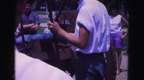 1964: man in blue and white is loading cannon put on cart WILLIAMSBURG Stock Footage