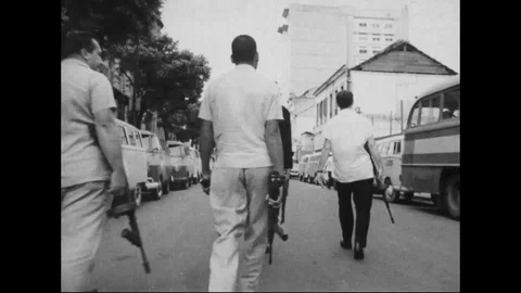 1964 - Men walking with guns, men sleeping on floors and tables, and a group of Stock Footage 125698157