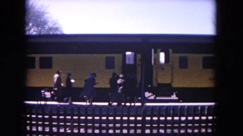 1964: people are walking into a train and then the train stars moving. EVANSTON Stock Footage