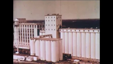 1964 Shots of a grain elevator and cereal processing plant, and inspectors Stock Footage 115373188