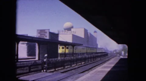 1964: train leaving station heading into big futuristic city EVANSTON, ILLINOIS Stock Footage