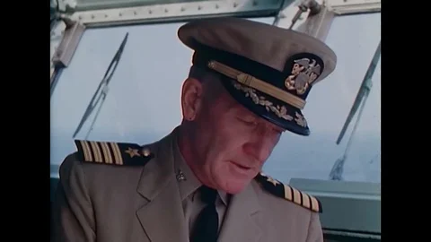 1965 - Captain Smith and his commanders keep a lookout on the bridge of the USS Stock Footage 115673814