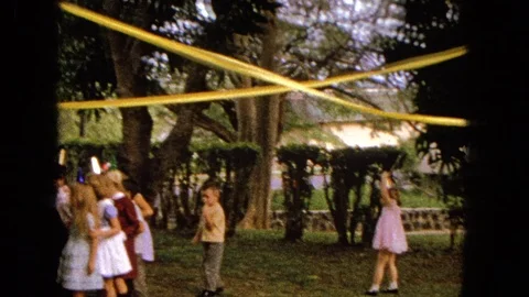 1965: Children Playing Outside At Easter Party In Suburban Backyard Stock Footage 120820082