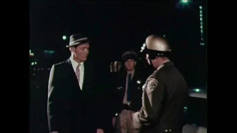 1965 - A drunk driver agrees to a sobriety test offered by the cop who pulled Stock Footage 155856700