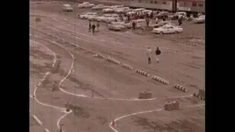 1965 - A drunk driving course is set up as a test, and other people drive Stock Footage 155854529