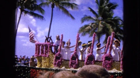 1965: EASTER MOLOKAI BEACH PARADE ALOHA TOWER WITH FLORAL FLOATS AND PALM TREES Stock-Footage 120819799