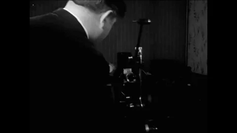 1965 - A lightbulb slips down the pant-leg of clumsy film enthusiast as he sets Stock Footage 83422026