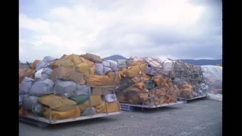 1965 - Mail stacks at the An Khﾐ Army Airfield are unloaded and soldiers load Stock Footage 232892826