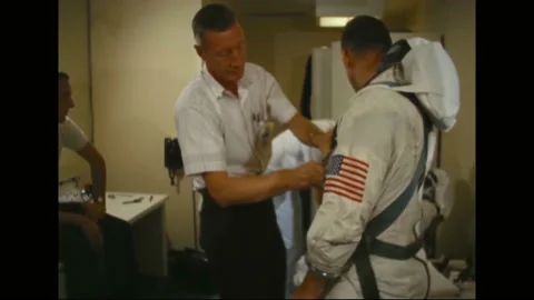 1965 - NASA technicians help Michael Collins, Frank Borman, Jim Lovell and Ed Stock Footage 232850408