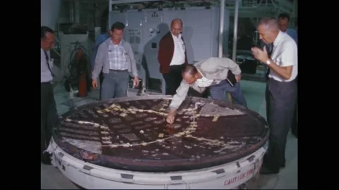 1965 - NASA technicians work on a heat shield at the Mission Control Center. Stock Footage 232849463