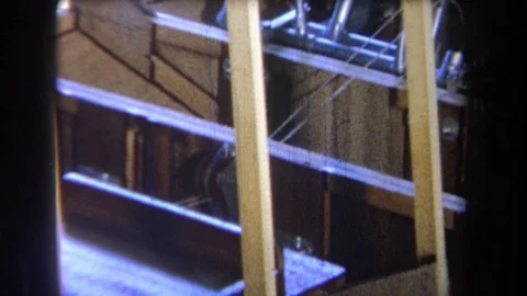1965: Pulley Centered Between Thin Cords Extending Into Large Wooden Structure Stock Footage 70186677