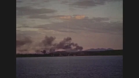 1965 - Shells explode over White Beach in Vietnam. US Navy planes fly through Video stock 115554603