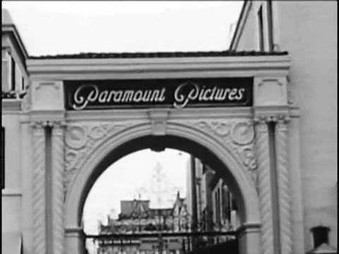 1965- A shot of the front gate at Paramount studio, and Frank Capra receives a Stock Footage 79456230