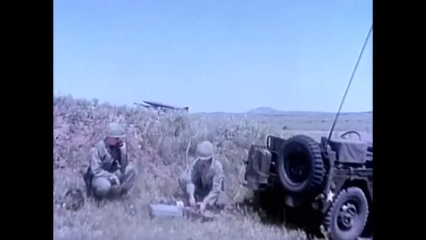 1965 - Soldiers use a remote control panel to fire an Honest John Stock Footage