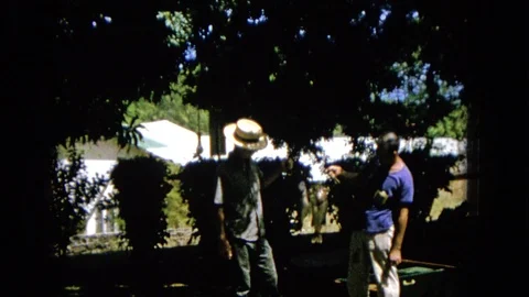 1965: Two Men Display Freshly Caught Fish in Backyard Super 8 Footage Vidéo 120819138
