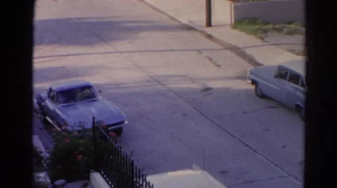 1966: classic blue corvette stingray car driving out from above viewpoint Stock Footage