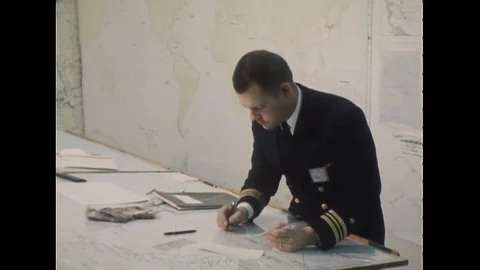 1966 - Lieutenant Commander J.F. Greene of the US Navy uses a plotting board. 動画素材 106899338