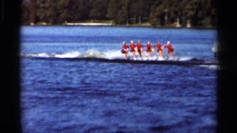 1966: People Running Across Waves at a Large Body of Water in Florida Stock Footage 73370261