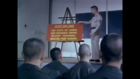 1966 - Recruits do pushups and pull-ups and they train with rifles and run Stock Footage 83417725