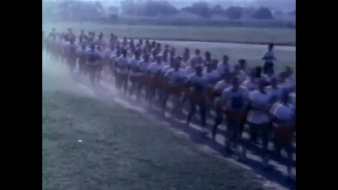 1966 - Recruits run and exercise on a field and a Senior Drill Instructor yells Video stock 83417702