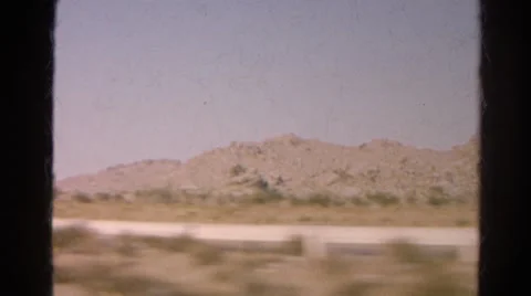 1966: rugged dirt road cutting through the mountains as seen from moving vehicle Stock Footage