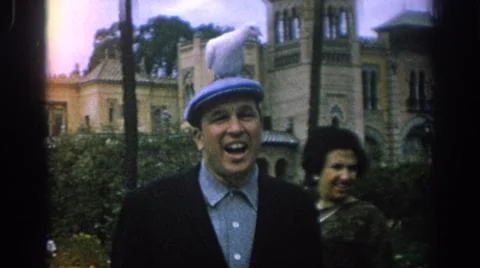 1966:SPAIN. Large Brown Building Multiple Towers With Palm Trees And Man In Blue Fotos de archivo