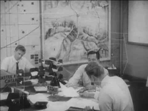 1967 _An officer records and plots data on a map during a radiological hazard at Stock Footage