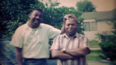1967: African American brothers clowning around in suburban driveway. CARMEL, Stockbeeldmateriaal 59082436