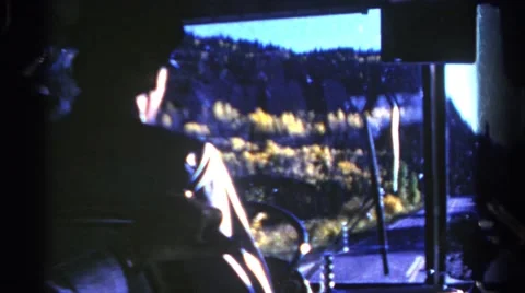 1967: driver traveling along country road passing some hills along the way Stock Footage