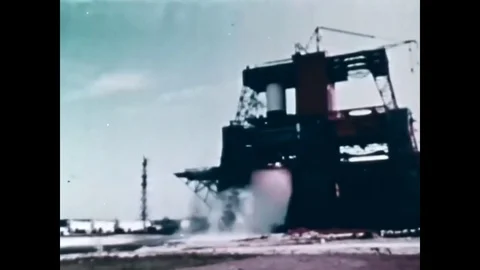 1967 - An engine is fired on a test stand and an Apollo Saturn V spacecraft Stock Footage 82803269