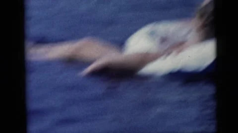 1967: family time at the lake as children swim and parents look on to supervise Stock Footage