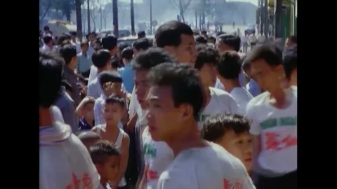 1967 - Firecrackers are set off in front of performers dressed as a dragon for a Stock Footage 120415141