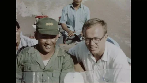 1967 - With help from an American representative of an aid program, Vietnamese Stock Footage 124504562