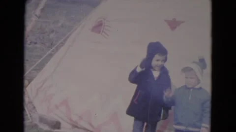 1967: kids gesturing while standing in front of wood fire LINCOLN, NEBRASKA Stock Footage