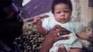 1967: Proud African American Dad Holds Up New Baby Girl. Carmel, Indiana Stock Footage