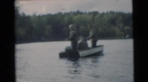 1967: three men having fun fishing on a lake in a boat. CAMDEN, NEW JERSEY Stock Footage