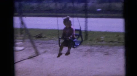 1967: Two Children Playing on Swing Set in Camden Backyard Stock Footage 67668182