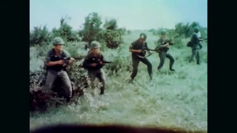1967 Vietnam - US soldiers turn around and firing their weapons Stock Footage
